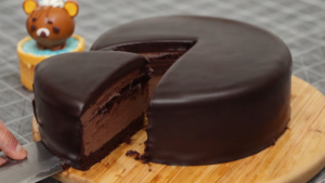 Chocolate cheesecake baking in the oven, viewed through the oven door